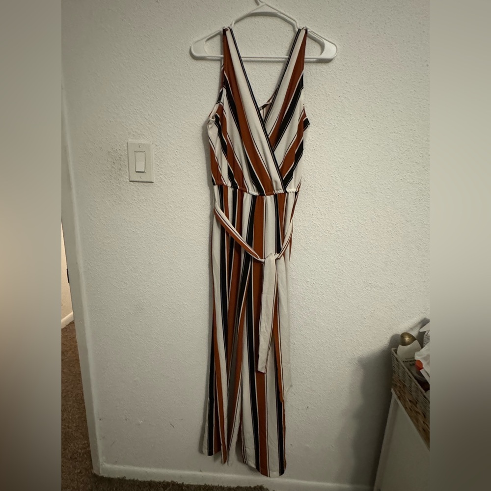 Never worn jump suit with vertical stripe